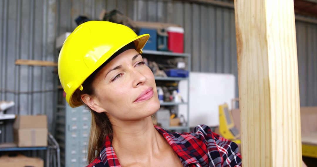 Female Carpenter in Workshop Wearing Helmet Concentrating on Task - Free Images, Stock Photos and Pictures on Pikwizard.com