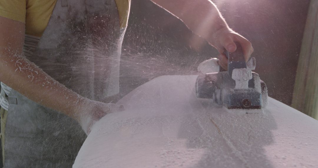 Craftsman Shaping Wood with Power Tool Amidst Flying Sawdust - Free Images, Stock Photos and Pictures on Pikwizard.com