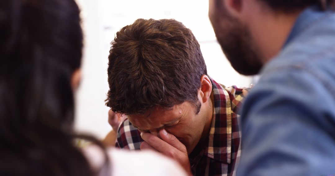 Man Crying with Friends Offering Support in Difficult Moment - Free Images, Stock Photos and Pictures on Pikwizard.com