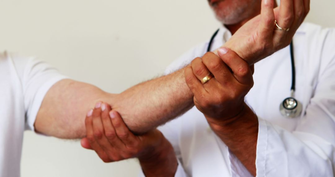 Senior Doctor Examining Patient's Forearm in Medical Office - Free Images, Stock Photos and Pictures on Pikwizard.com