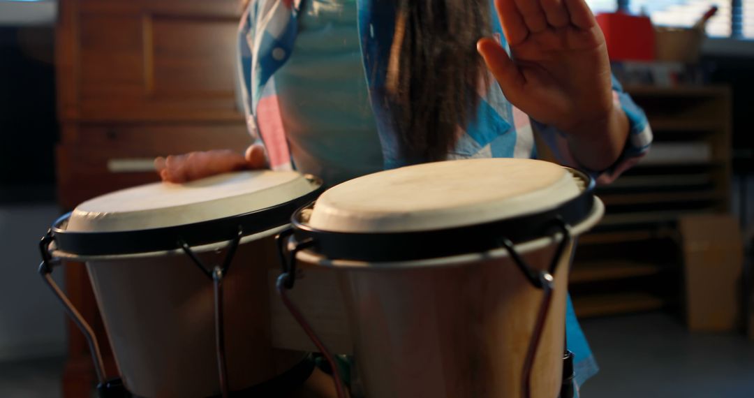 Person Playing Bongo Drums Indoors - Free Images, Stock Photos and Pictures on Pikwizard.com