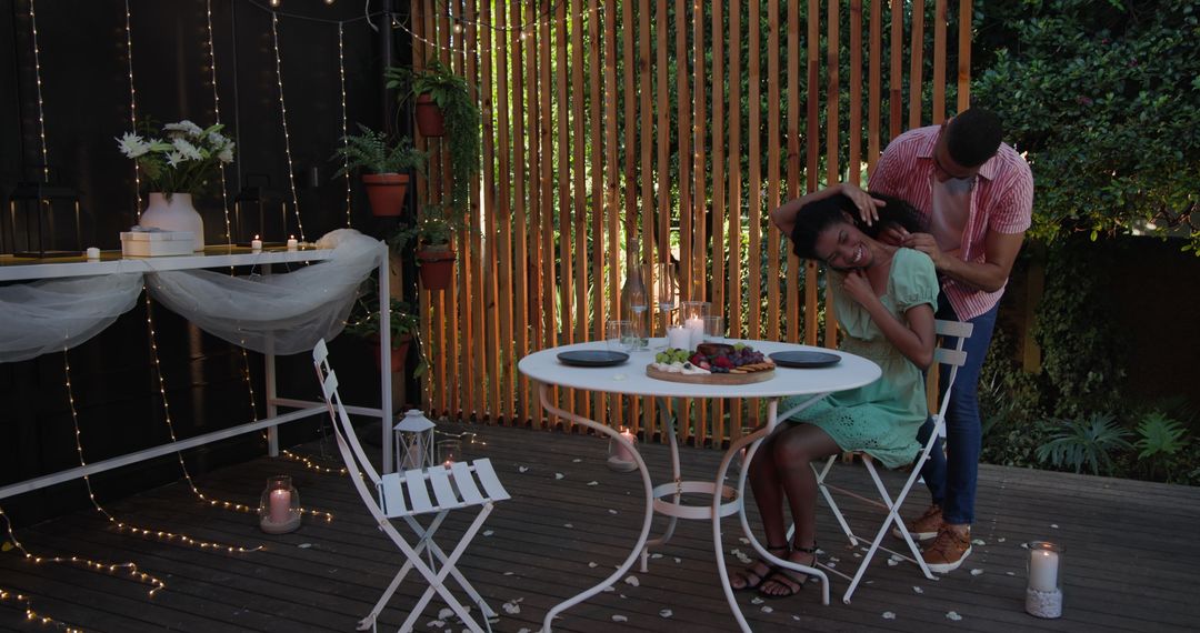 Romantic Candlelit Dinner for Diverse Couple in Garden Setting