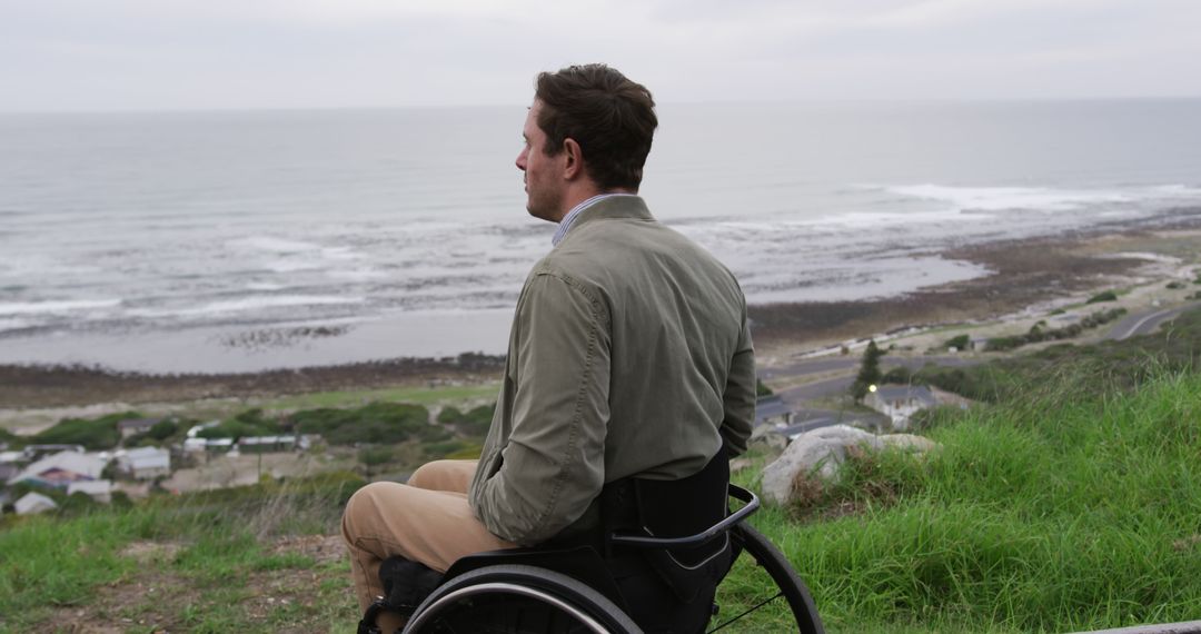 Man in Wheelchair Overlooking Scenic Ocean View - Free Images, Stock Photos and Pictures on Pikwizard.com