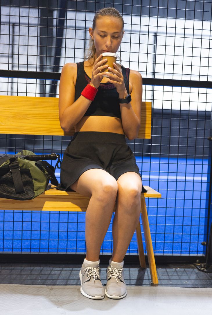 Athlete Enjoying Coffee Break Post-Workout in Modern Facility