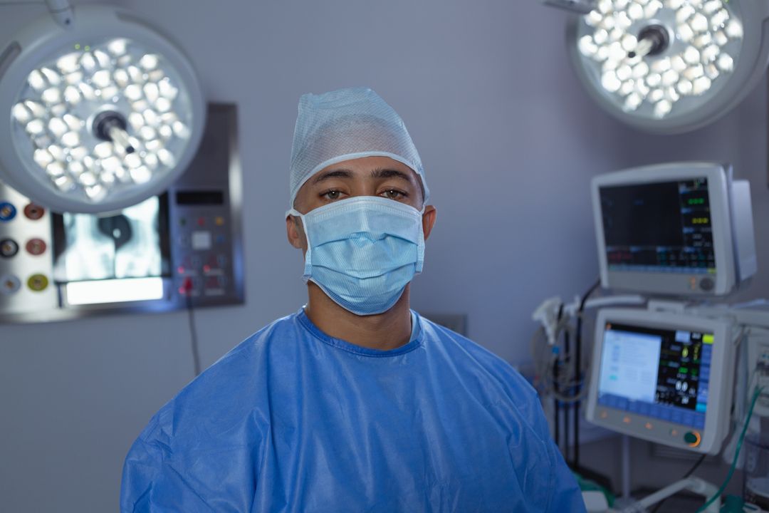 Male surgeon looking at camera while standing in operation room at hospital - Free Images, Stock Photos and Pictures on Pikwizard.com