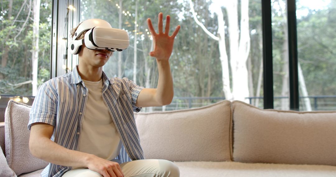 Man Wearing VR Headset Relaxing on Sofa with Nature View