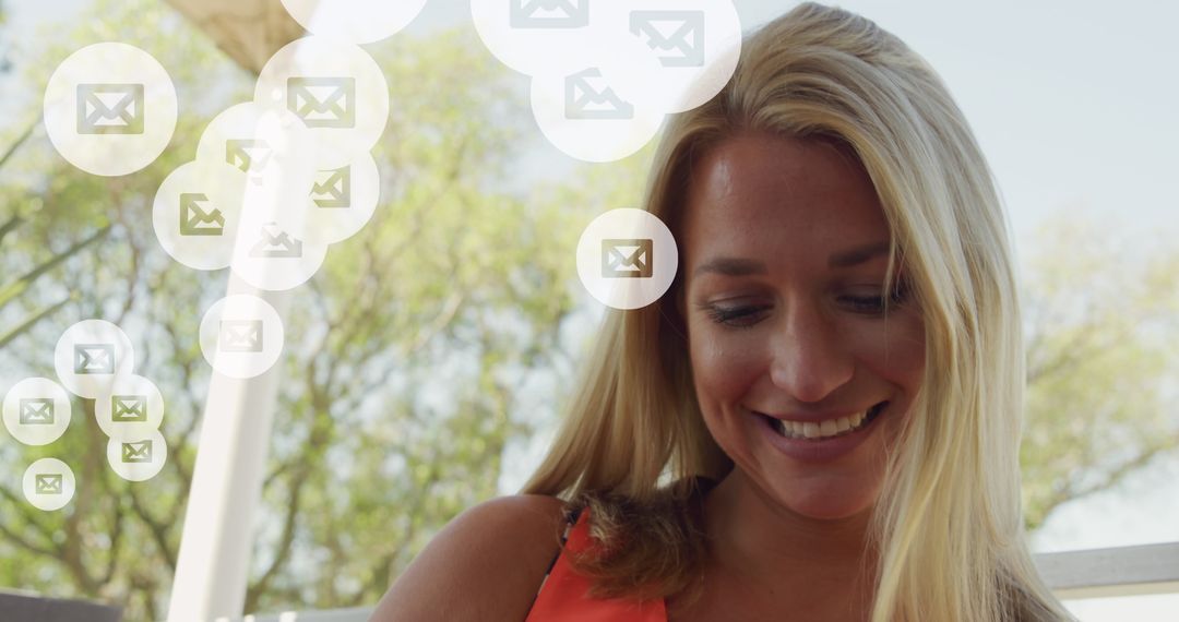 Smiling Woman Engaged with Digital Messaging Interface Outdoors