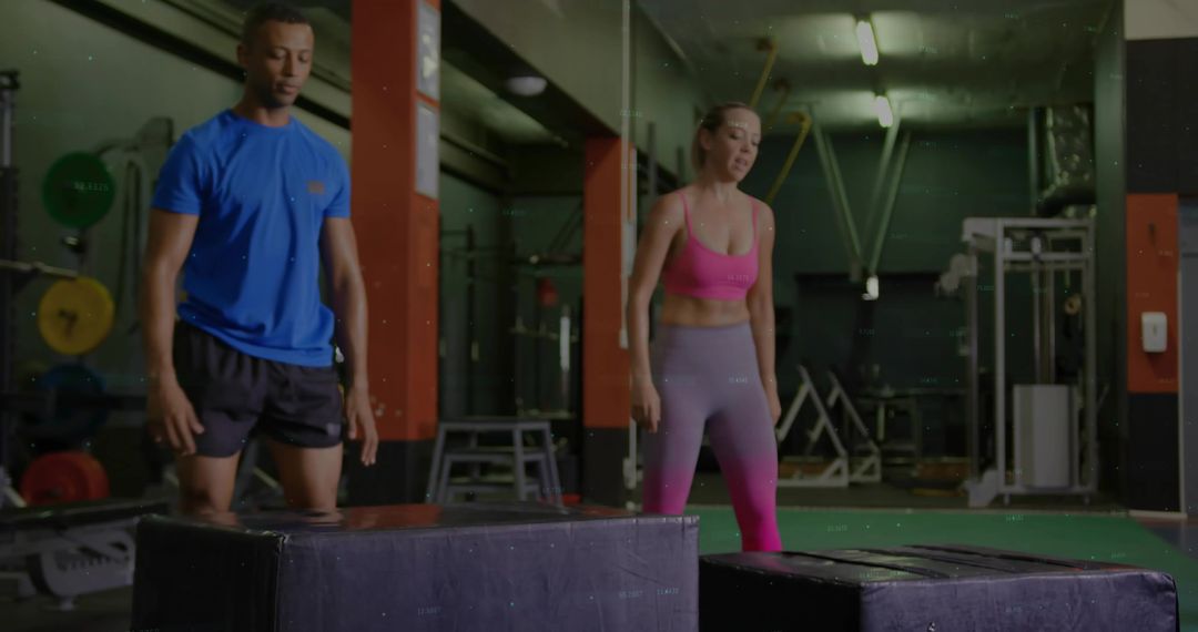 Athletic Partners Performing Plyometric Box Jumps in Fitness Center