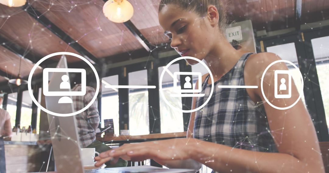 Woman Engaging with Digital Network on Laptop in Modern Café
