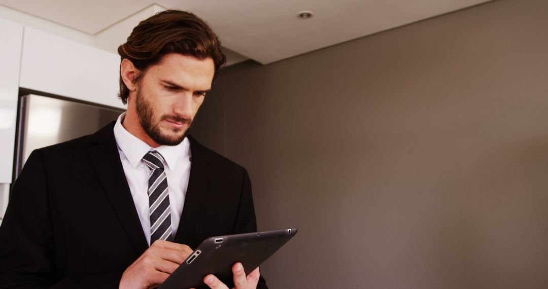 Businessman Working on Digital Tablet Remotely in Home Setting 4k Resolution - Free Images, Stock Photos and Pictures on Pikwizard.com