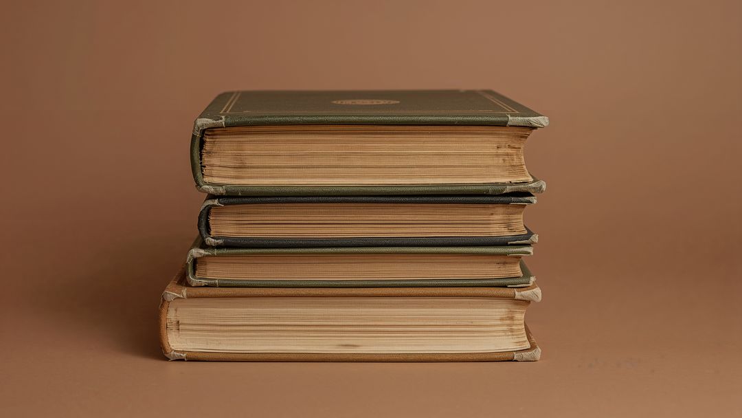 Stack of Vintage Hardcover Books with Yellowed Pages
