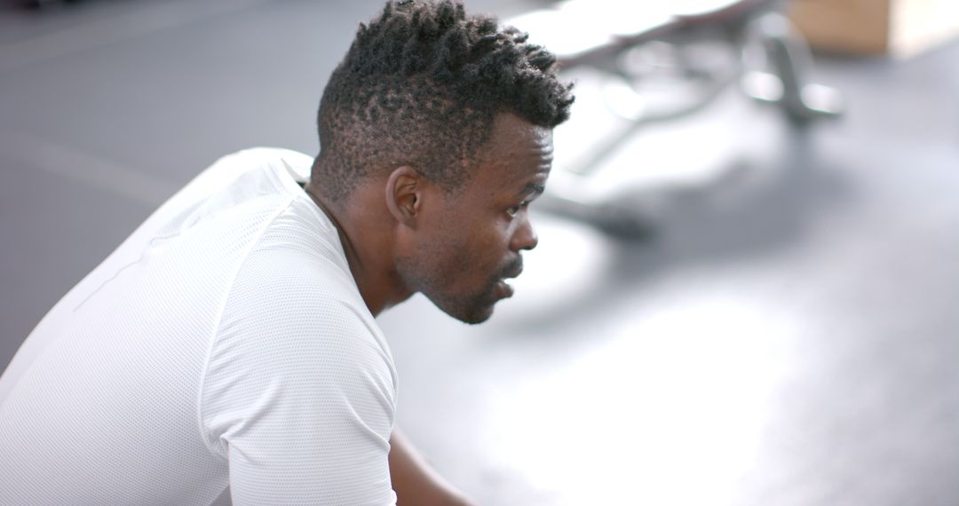 Determined Athlete Taking Break in Gym With Focused Expression