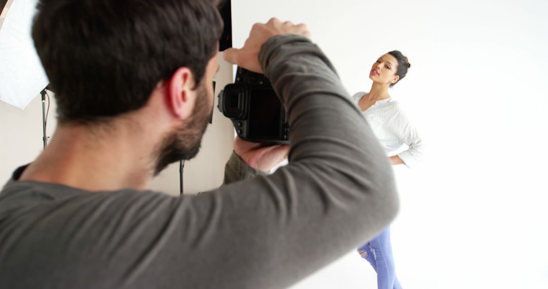 Professional Photographer Capturing Model in Studio for Photo Shoot - Free Images, Stock Photos and Pictures on Pikwizard.com