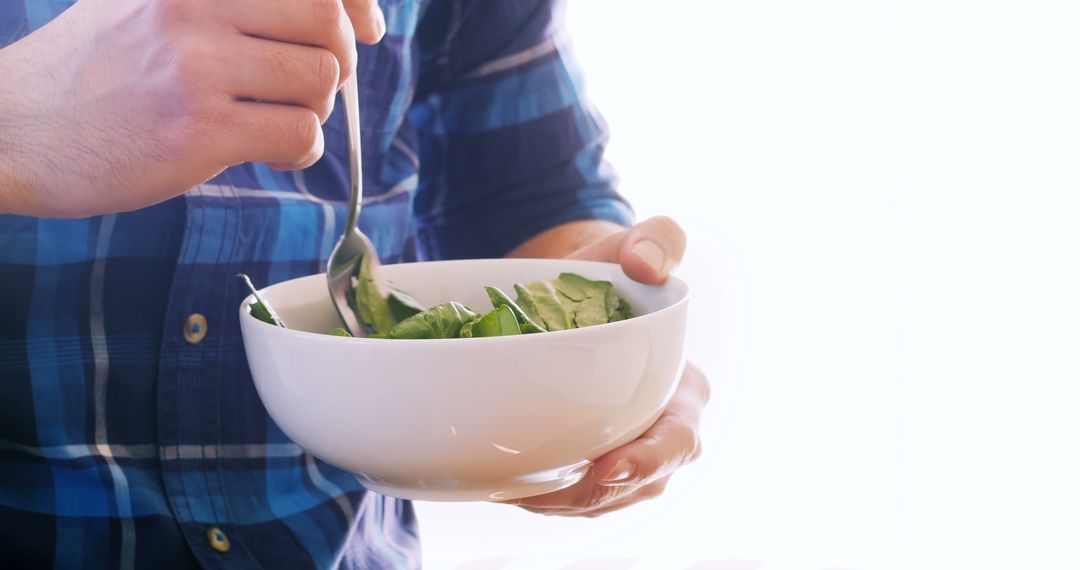 Man Eating Fresh Salad with Spoon in Casual Outfit - Free Images, Stock Photos and Pictures on Pikwizard.com