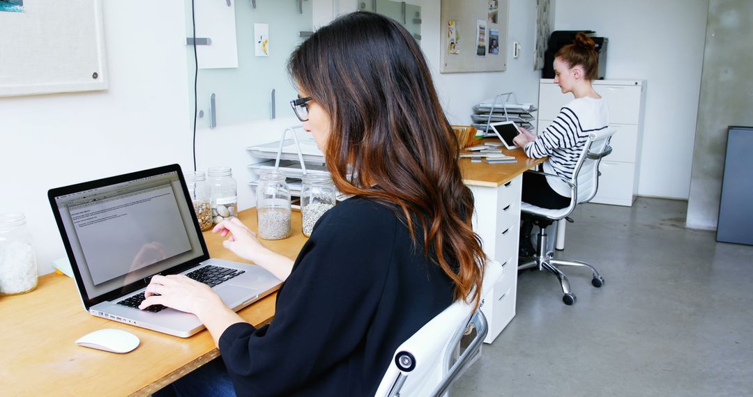 Women Working on Laptops in Modern Office Workspace - Free Images, Stock Photos and Pictures on Pikwizard.com