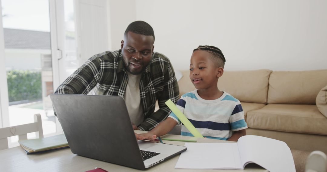 African American Father and Son Using Laptop for Homework at Home - Free Images, Stock Photos and Pictures on Pikwizard.com