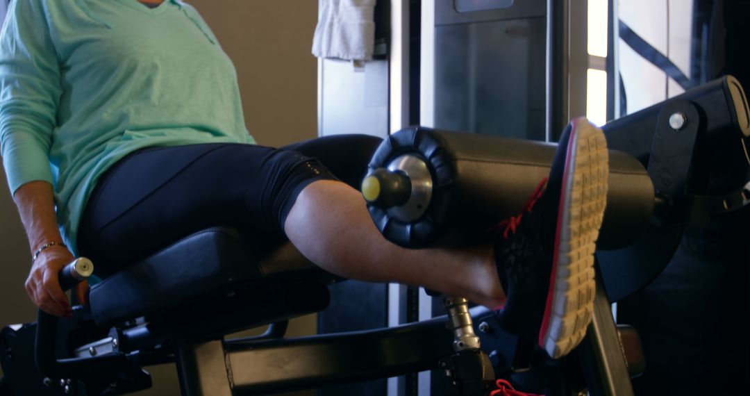 Woman Using Leg Extension Machine at Gym - Free Images, Stock Photos and Pictures on Pikwizard.com