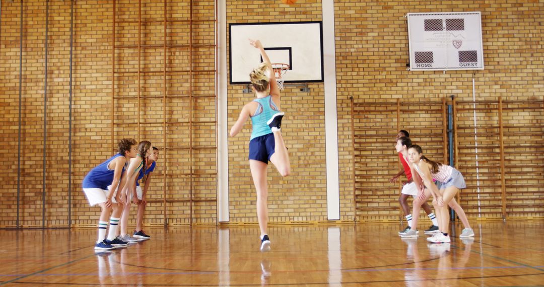 Female Basketball Team Practicing in Gymnasium - Free Images, Stock Photos and Pictures on Pikwizard.com