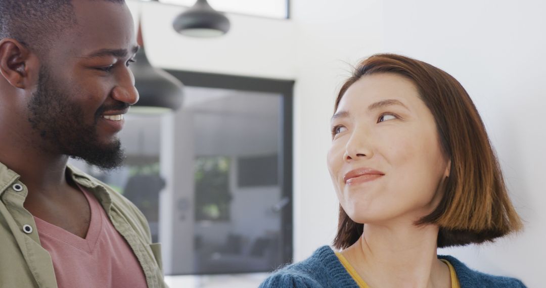 Image of happy diverse couple smiling at each other at home - Free Images, Stock Photos and Pictures on Pikwizard.com