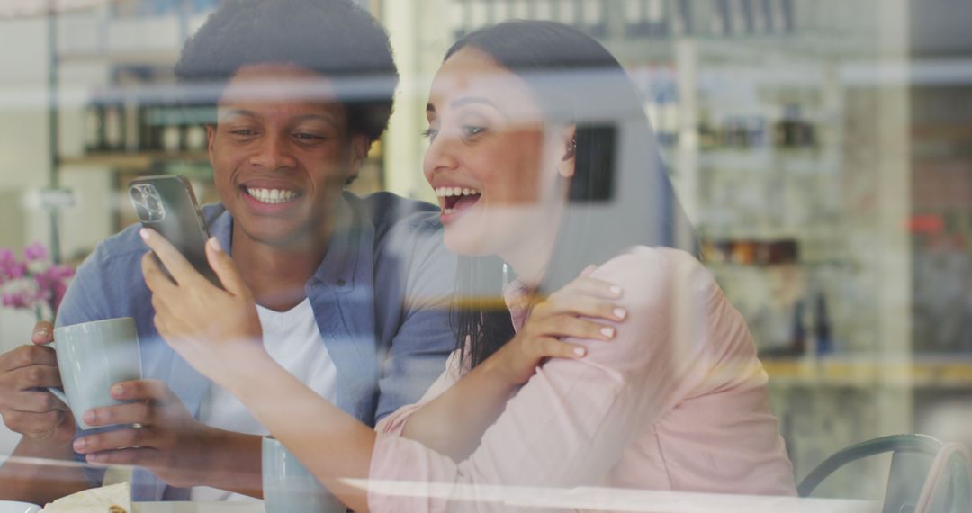 Joyful Friends Enjoying Coffee and Conversation in Cafe
