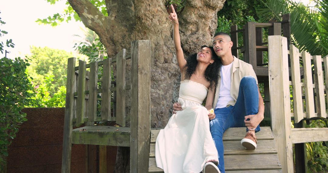 Couple Relaxing on Wooden Platform in Lush Garden