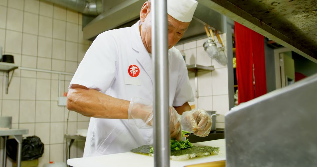 Experienced Sushi Chef Preparing Fresh Sushi Rolls in Professional Kitchen - Free Images, Stock Photos and Pictures on Pikwizard.com