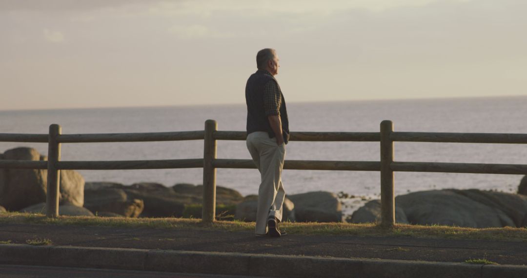 Elder man contemplating by the ocean at sunrise - Free Images, Stock Photos and Pictures on Pikwizard.com