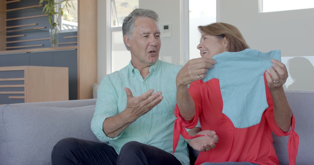 Senior Couple Enjoying Gift Unwrapping at Home