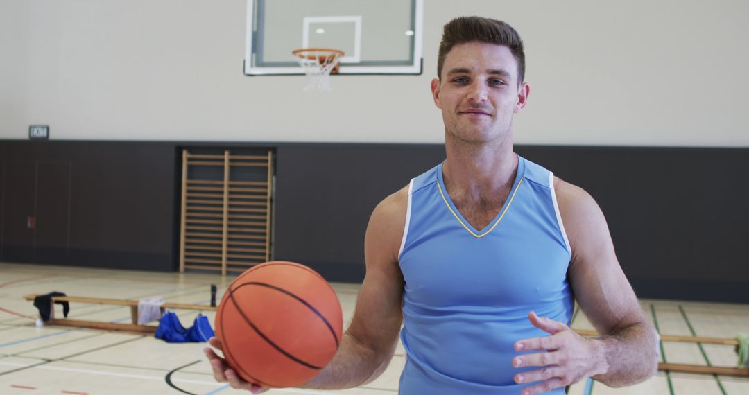 Young Basketball Player Holding Ball in Gym - Free Images, Stock Photos and Pictures on Pikwizard.com