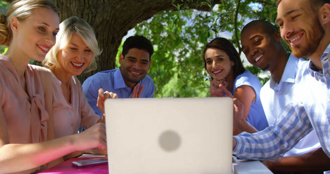 Group of Colleagues Collaborating Outside on Laptop - Free Images, Stock Photos and Pictures on Pikwizard.com