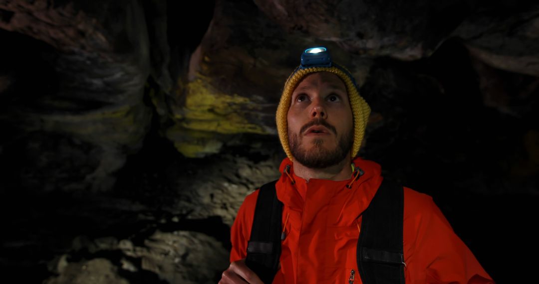 Man Exploring Dark Cave Wearing Headlamp and Red Jacket - Free Images, Stock Photos and Pictures on Pikwizard.com