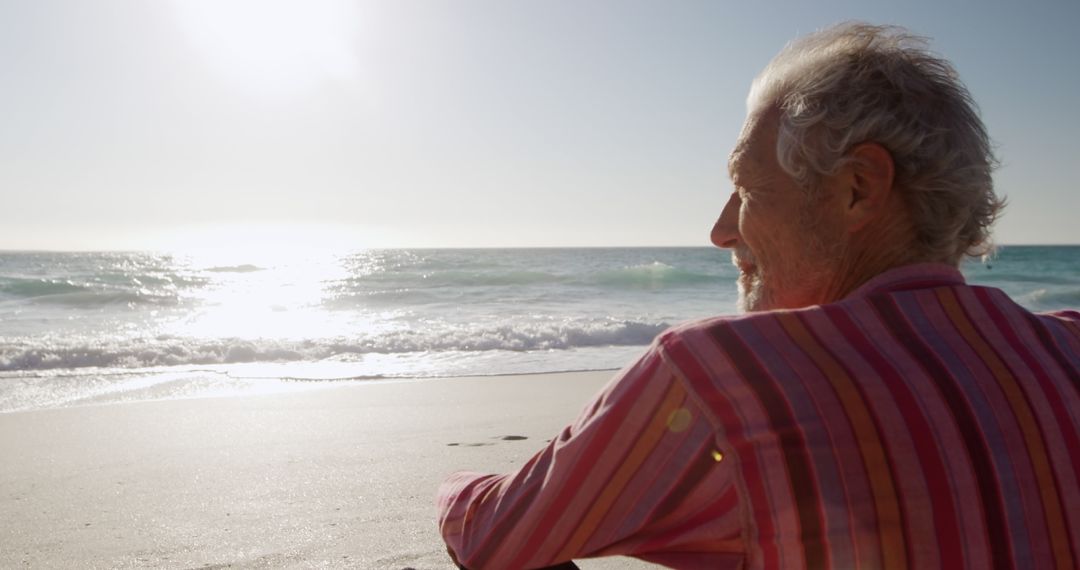 Elderly Man Contemplating Ocean at Sandy Beach During Sunset - Free Images, Stock Photos and Pictures on Pikwizard.com