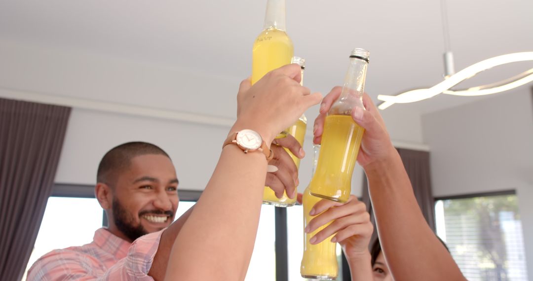 Diverse Friends Toasting with Beer Bottles In Casual Meeting
