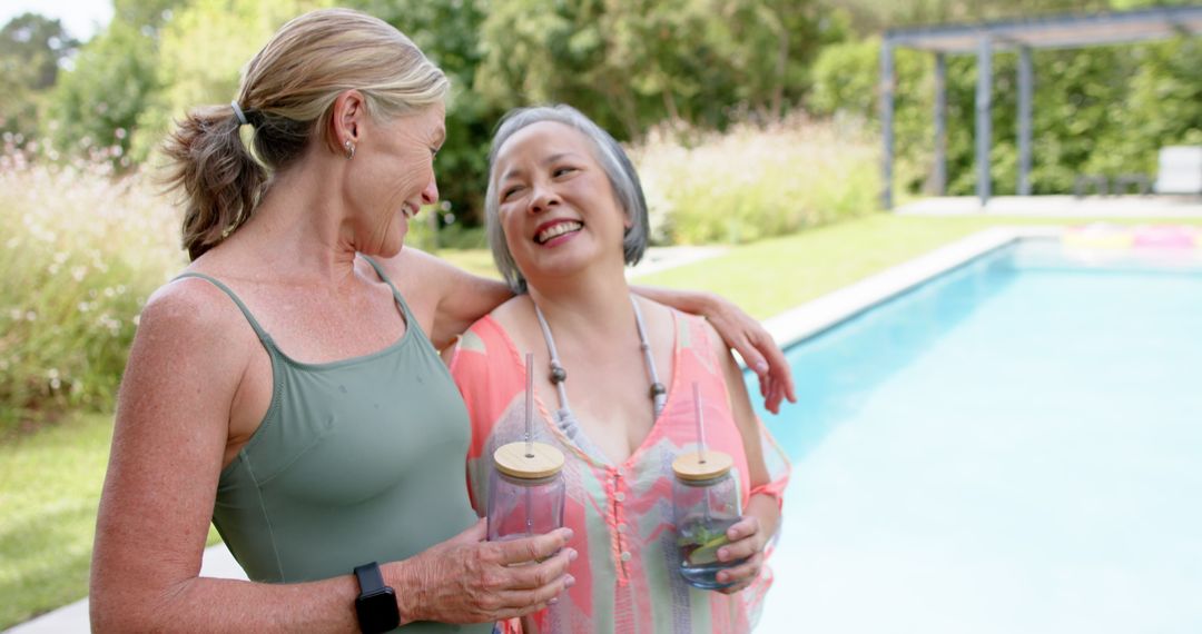 Mature Friends Enjoying Poolside Summer Moments with Drinks
