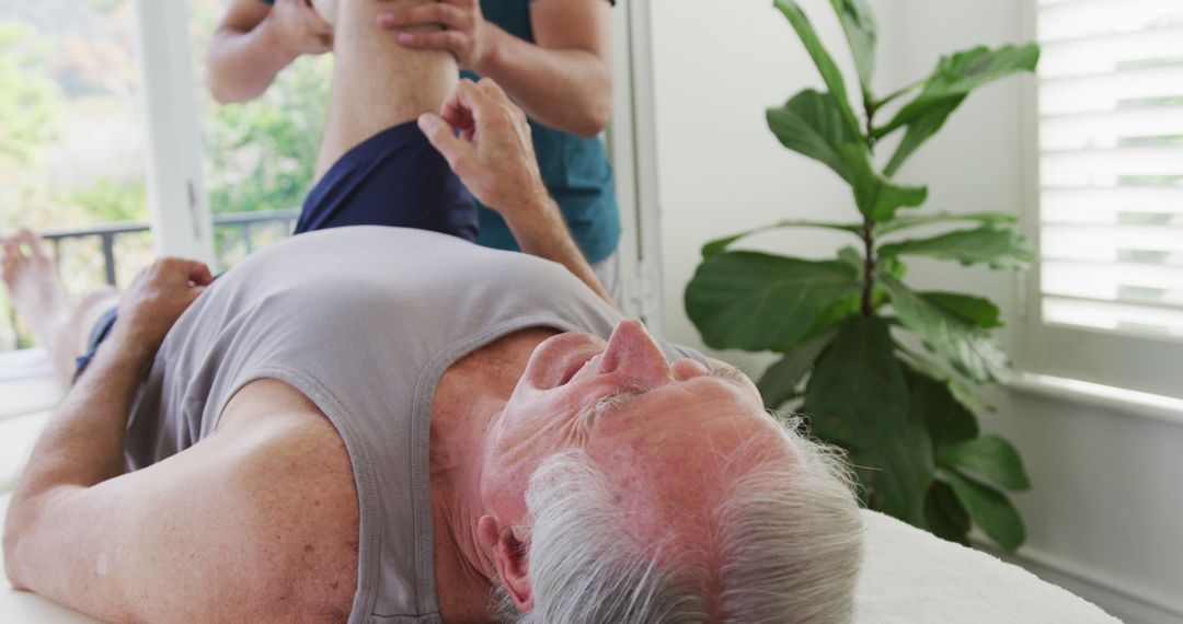 Older Man Receiving Physical Therapy at Home - Free Images, Stock Photos and Pictures on Pikwizard.com