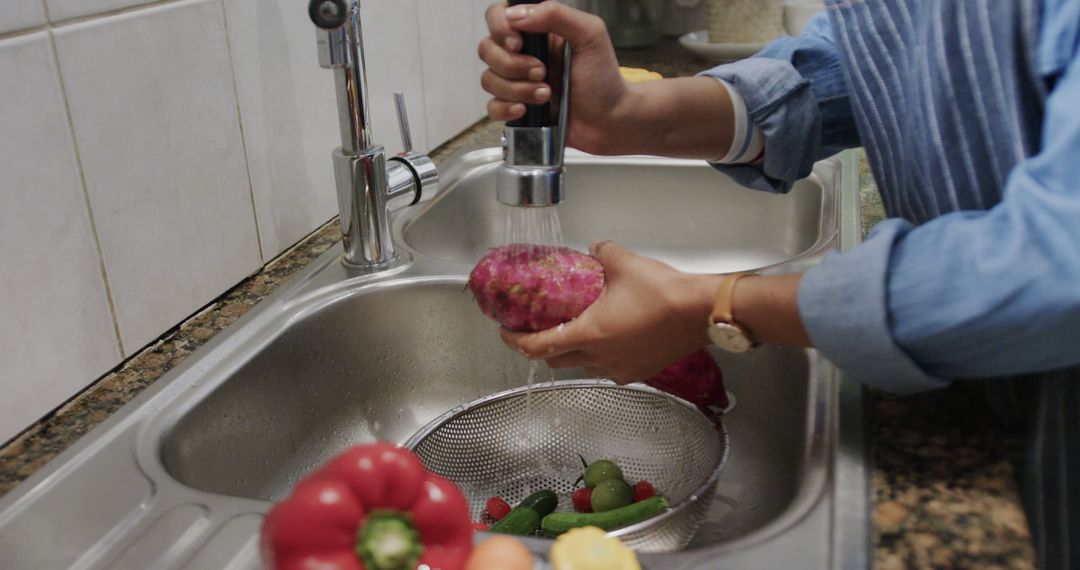 Person Washing Vegetables in Kitchen Sink for Meal Preparation - Free Images, Stock Photos and Pictures on Pikwizard.com