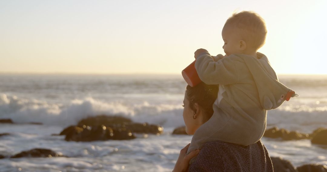 Mother Holding Toddler at Beach During Sunset - Free Images, Stock Photos and Pictures on Pikwizard.com