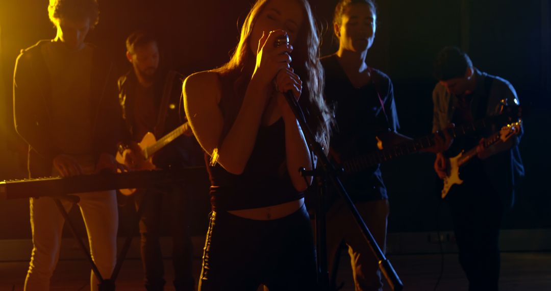 Energetic Band Performance with Female Lead Singer on Stage