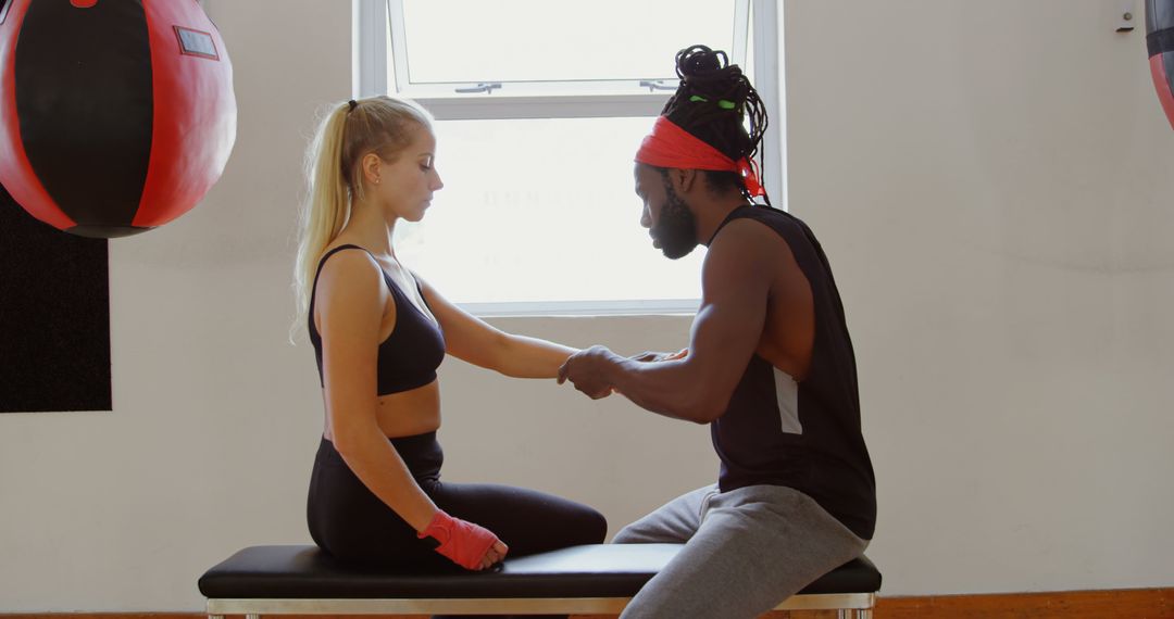 Boxing Trainer Helping Female Boxer with Hand Wraps in Gym - Free Images, Stock Photos and Pictures on Pikwizard.com