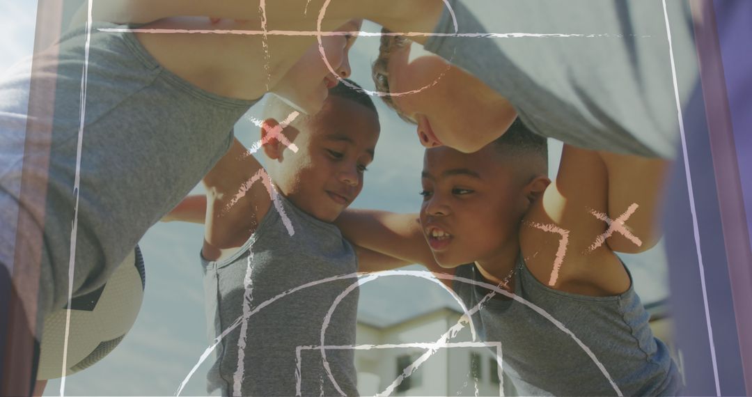 Diverse Schoolboys in Football Huddle with Game Plan