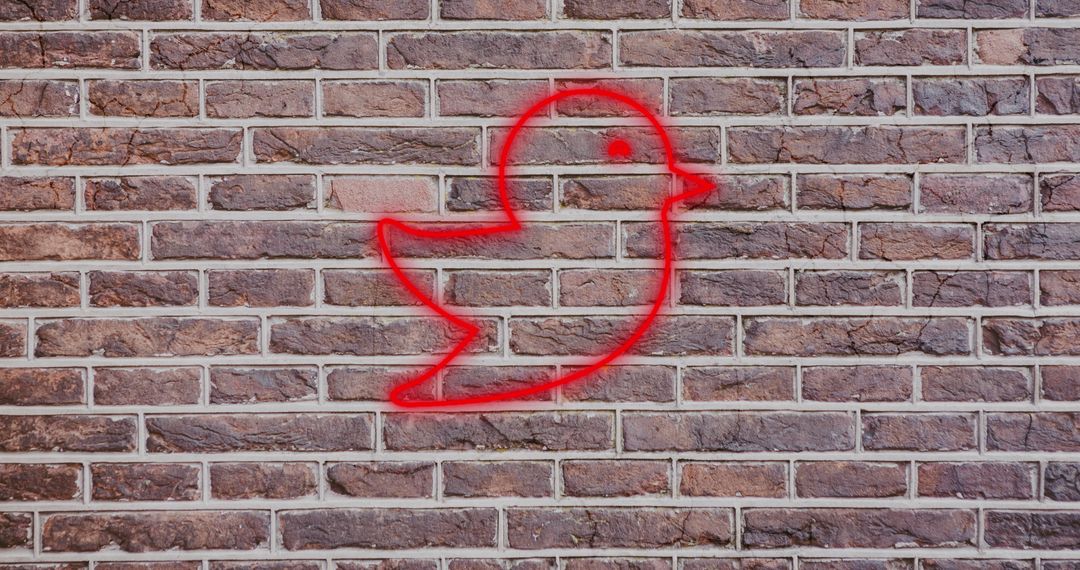 Illuminated Red Bird Icon on Brick Wall Background