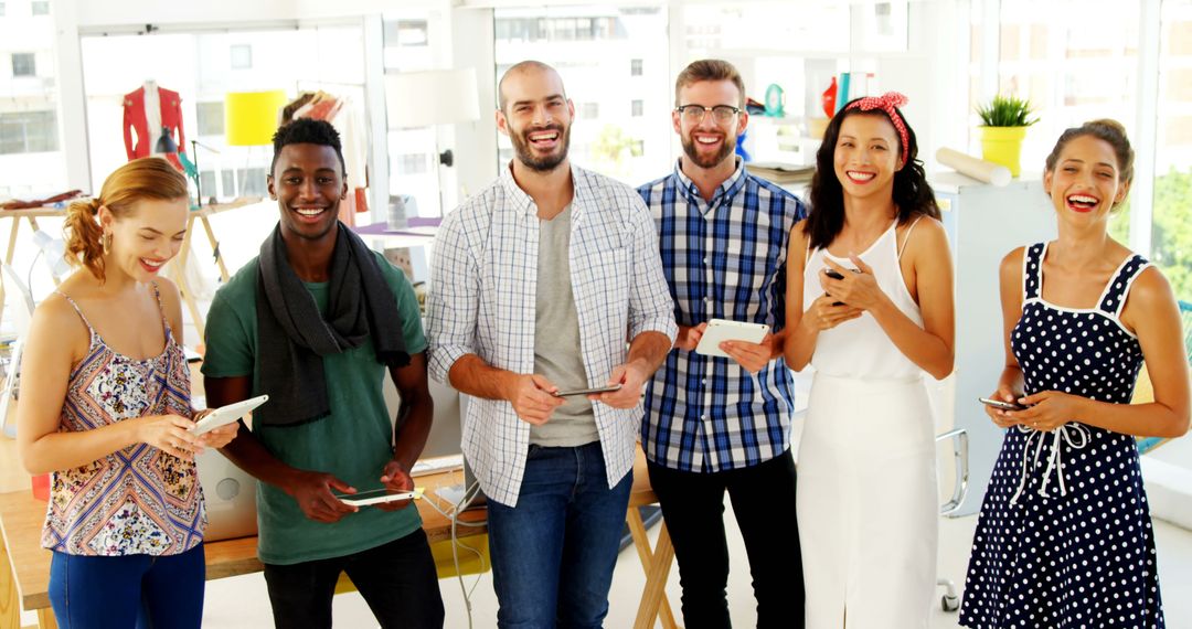 Diverse group of young adults sharing digital content during social gathering