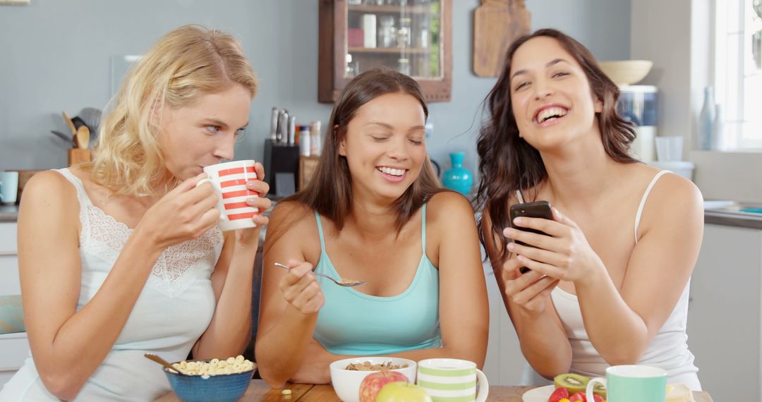 Three Young Women Enjoying Breakfast and Laughing Together - Free Images, Stock Photos and Pictures on Pikwizard.com