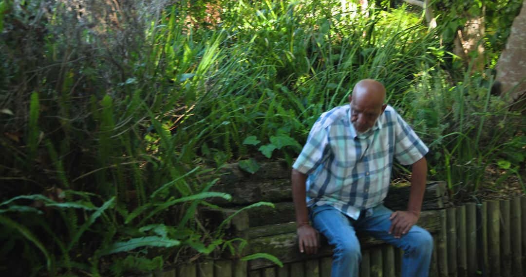 Senior Man Enjoying Garden Tranquility on Sunny Day