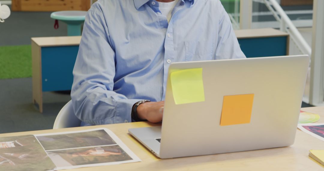 Businessman Working Indoors on Laptop with Sticky Notes - Free Images, Stock Photos and Pictures on Pikwizard.com