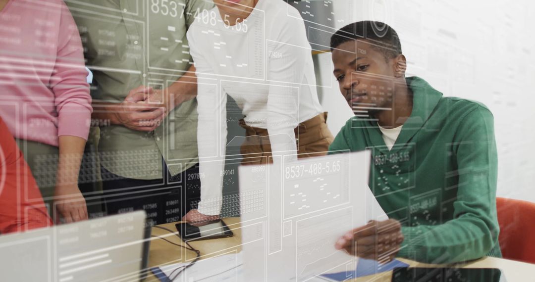 Diverse Team Collaborating Over Digital Data Interface in Modern Office