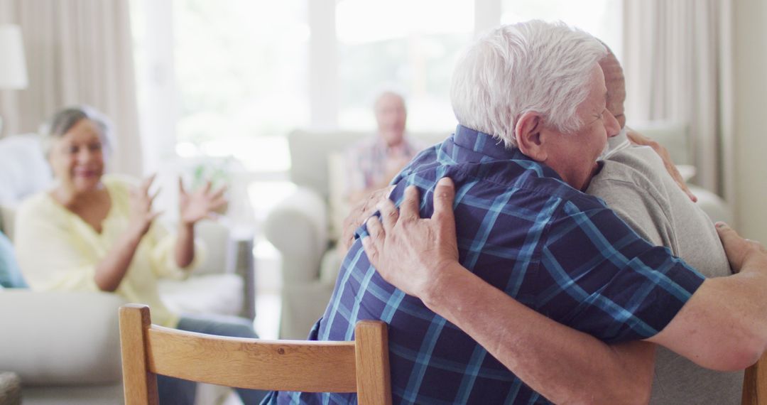 Senior Man Embracing Friend in Community Room with Applauding Audience - Free Images, Stock Photos and Pictures on Pikwizard.com