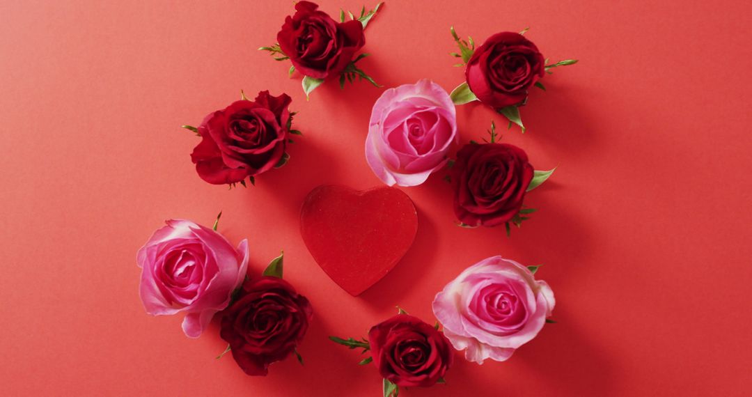 Heart Surrounding by Red and Pink Roses on Red Background