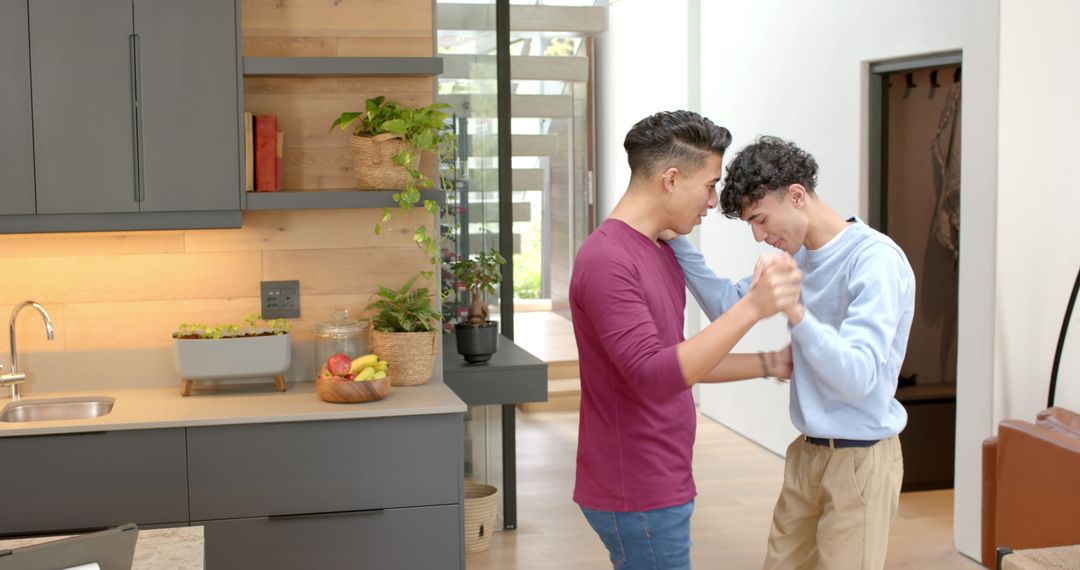 Romantic Diverse Male Couple Dancing in Stylish Kitchen