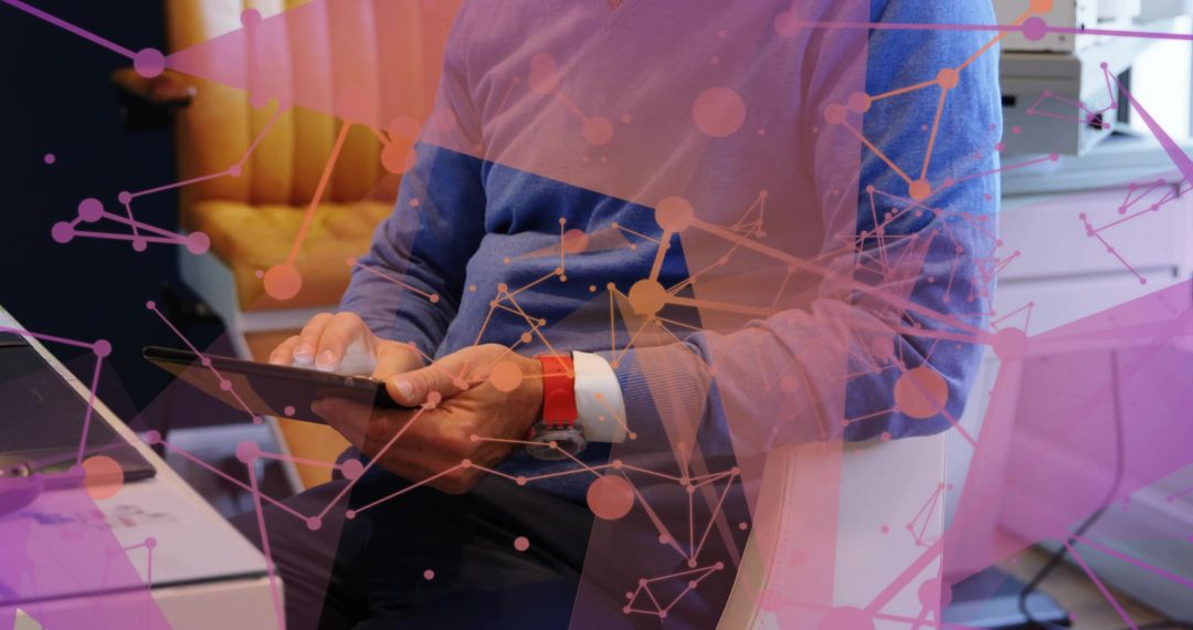 Mature professional holding tablet tapping screen with digital network overlay in modern workspace